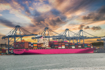 Logistics and container loading by large barges by sea in a harbor full of containers waiting to be...