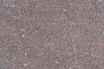 Background of small pebbles. Stone beach on the sea.