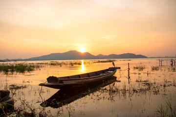 beautiful sunset sky and wood boat floating in bangpra water reservoir lake chonburi eatern of...