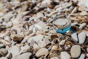 Reflection in glasses of the game of dad and son on the beach. The concept of joint recreation and travel.