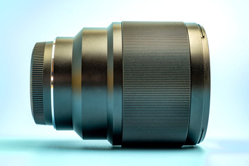 Optical digital camera lens isolated on blue background.
