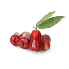 Ripe red rose apple fruit over transparent tray
