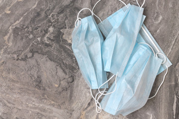 Group of protective medical masks for the prevention of coronavirus infection ncov-19 on a gray background.