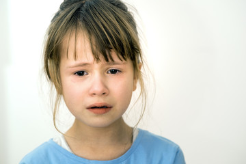 Closeup portrait of sad crying child girl.