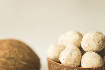 Fototapeta na wymiar homemade coconut energy balls with almond. healthy sugar free concept. keto diet recipe. close up view.