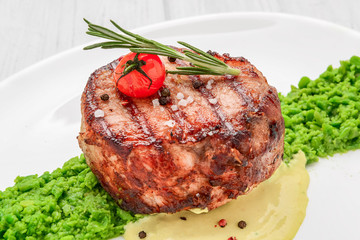 steak mignon with pea puree and cream sauce