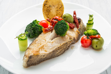 Fried halibut with vegetables and mustard, on the plate