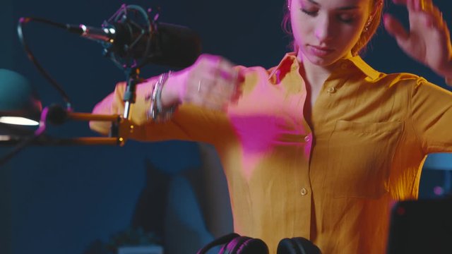 Young vlogger removing headphones after the live streaming show