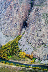 Waterfall in a mountain gorge. The confluence of the Karasu River into the Chulyshman River....