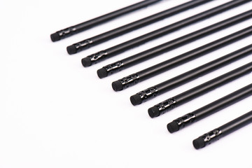 selective focus of black pencils with erasers isolated on white