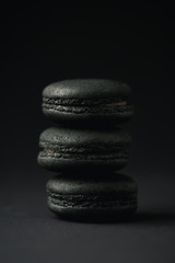sweet and dark macarons on black with copy space