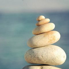 Pyramid of stones for meditation lying on sea coast