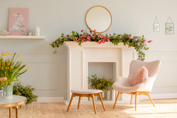 Home interior in blue tones with easter decoration. Spring flowers in a vase and blue Easter eggs...