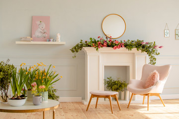 Home interior in blue tones with easter decoration. Spring flowers in a vase and blue Easter eggs...