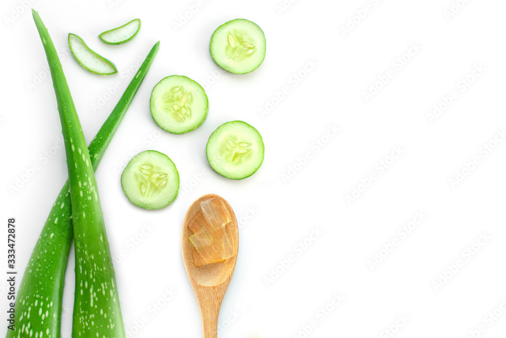 Sticker green fresh cucumber, aloevera leaf, and aloe gel in wooden spoon isolated on white background. natu