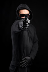 Man in black hoody with a gun