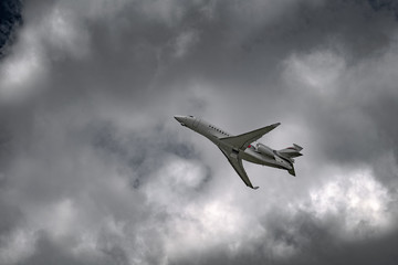 Airplane in the sky - cloudy day. Dramatic cloudy sky.