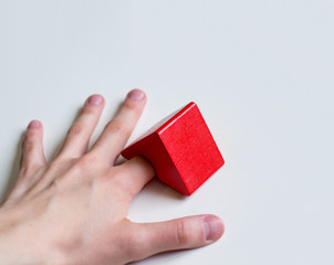 photo hand on a white background with a finger under the red roof