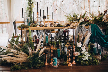banquet tables decorated with compositions of greenery and candles