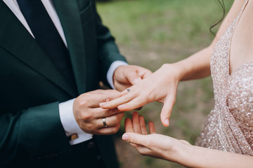 Couple exchanging rings at a wedding ceremony