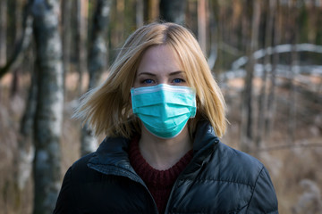 Woman in protective sterile medical mask on her face