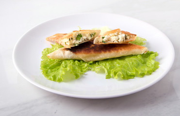Pita triangles with cottage cheese, herbs, on a white plate