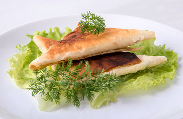 Pita triangles with cottage cheese, herbs, on a white plate