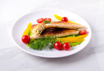 Pita triangles with cottage cheese, herbs, tomatoes on a white plate