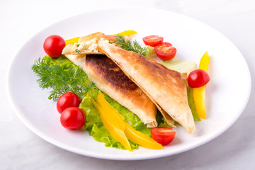 Pita triangles with cottage cheese, herbs, tomatoes on a white plate