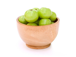 Indian gooseberry in wooden bowl  isolated on white background. 