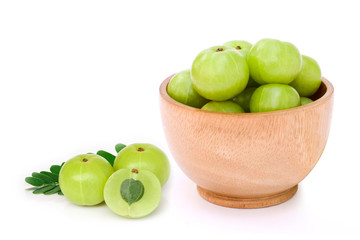 Amla fruit or Indian gooseberry ( phyllanthus emblica ) in wooden bowl with slice isolated on white background. 