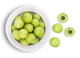 Closeup Indian gooseberry fruits ( phyllanthus emblica, amla ) in ceramic bowl isolated on white background. Top view. Flat lay.