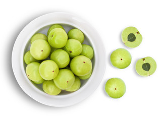 Closeup Indian gooseberry fruits ( phyllanthus emblica, amla ) in ceramic bowl isolated on white background. Top view. Flat lay.