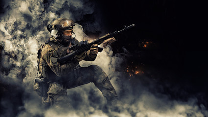 Portrait of a special forces soldier who reloads an assault rifle. The concept of military units....