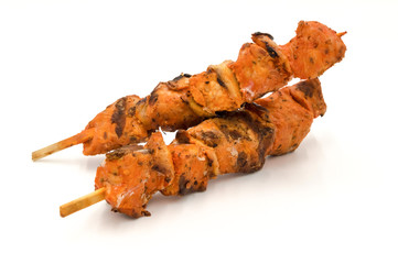 Grilled pork skewers isolated on white background