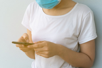 Women wearing protective masks Playing mobile