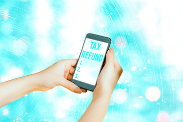 Conceptual hand writing showing Tax Refund. Concept meaning refund on tax when the tax liability is...