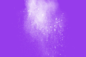 White powder drops on purple background