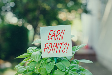 Writing note showing Earn Points. Business concept for collecting scores in order qualify to win...