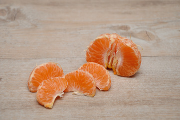 A peeled mandarin broken up in to pieces