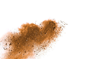 Freeze motion of brown color powder exploding on white background. 