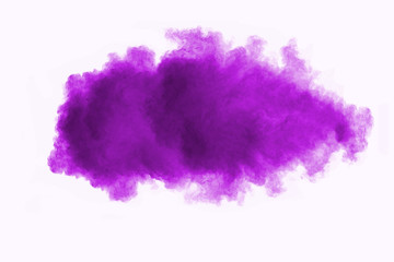 Freeze motion of purple color powder exploding on white background.