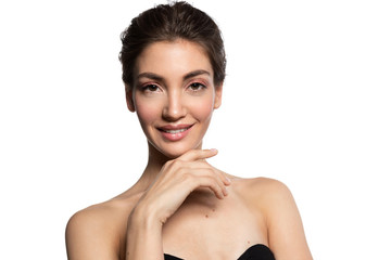 Fototapeta premium Charming smiling woman with perfect skin looking at camera and holding hand at chin on white background.