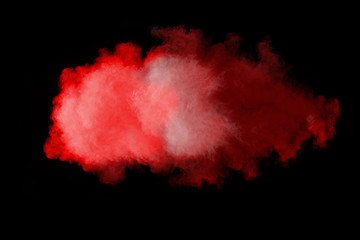 Red powder explosion isolated on black background.