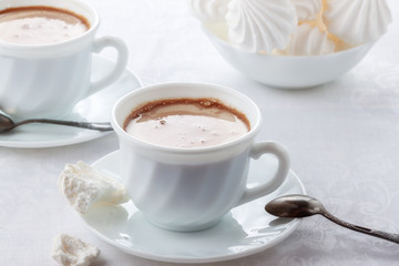 A cup of fresh coffee with cream and a gentle, airy Bizet