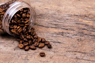 aromatic coffee beans dropped out of a glass jar. Banner background