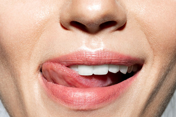 Beautiful perfect  lips with  tongue touches snow-white teeth. 