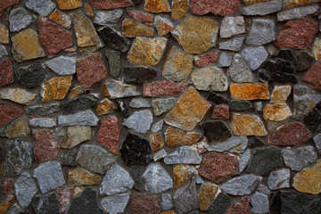 Texture of colored stone pebble wall for background