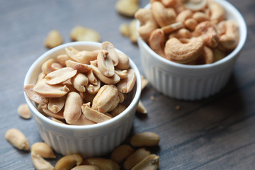 nuts, cashew, almonds, green nuts in the little bowl put on wood tray. snack food for coffee break 