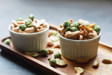 nuts, cashew, almonds, green nuts in the little bowl put on wood tray. snack food for coffee break 
